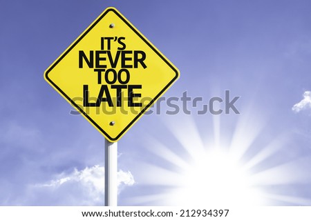 It's Never too Late road sign with sun background Royalty-Free Stock Photo #212934397