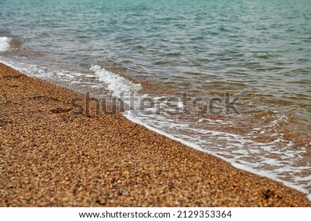 sandy beach with coarse sand and waves