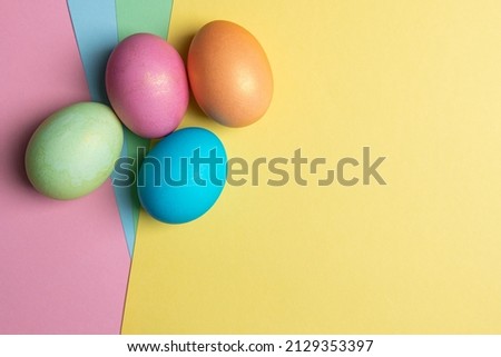 several colored eggs lie on colored backgrounds