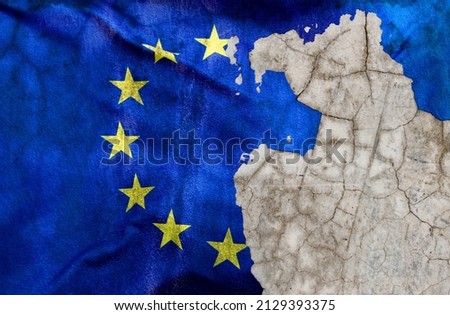 European Union flag on old wall with peeling paint.