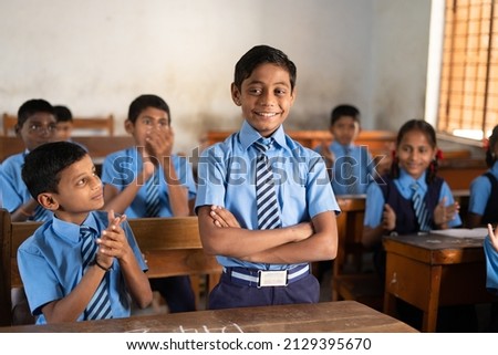 All students clapping for intelligent or brilliant kid at classroom for achievement - concept of encouragement, proud, motivational and inspiration Royalty-Free Stock Photo #2129395670