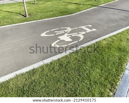 Bike Lane in city near car road, Bicyclist crossing bike lane, outdoors