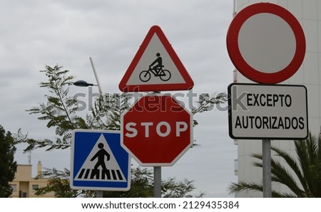 various road signs: "Entry forbidden to all vehicles except authorized ones, caution cyclists, stop road, pedestrian crossing", Alicante Province, Costa Blanca, Spain, February, 2022