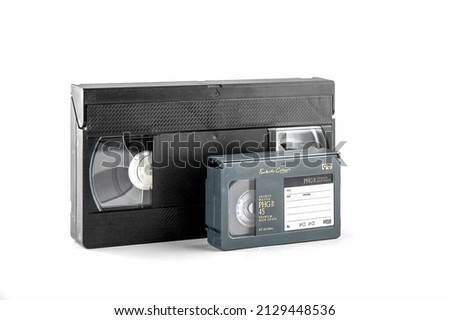 Old video cassettes on a white background in soft lighting. VHS and VHS-C (compact) systems