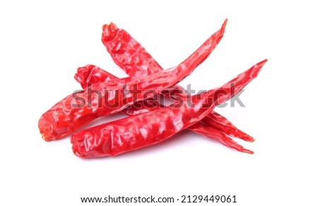 Dried red chillies on a white background