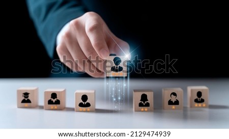 Human resource, Talent management, Recruitment employee, Successful business team leader concept. Hand chooses a wooden people standing out from the crowd. Royalty-Free Stock Photo #2129474939