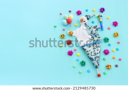 Holidays image of party with cute colorful clown over blue background. view from above
