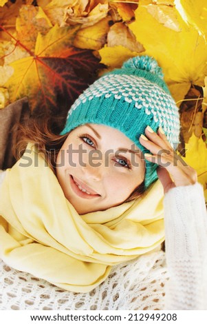 Happy beautiful woman in autumnal park