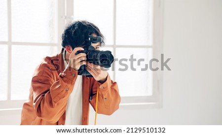 Photographer shooting photo in the shooting studio. Royalty-Free Stock Photo #2129510132