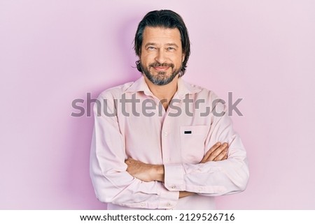 Middle age caucasian man wearing casual clothes happy face smiling with crossed arms looking at the camera. positive person. 