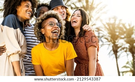 Multiracial young people laughing out loud on a sunny day - Cheerful group of best friends enjoying summer vacation together - Human resources, youth lifestyle and summertime holidays concept Royalty-Free Stock Photo #2129543387