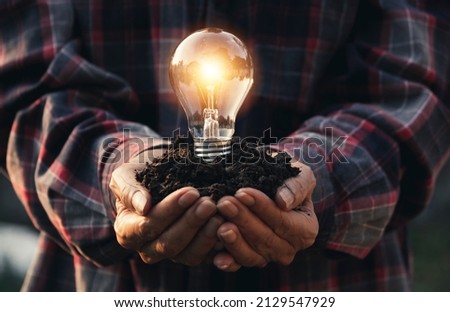 Innovation and energy concept of hand hold a light bulb and copy space for insert text.