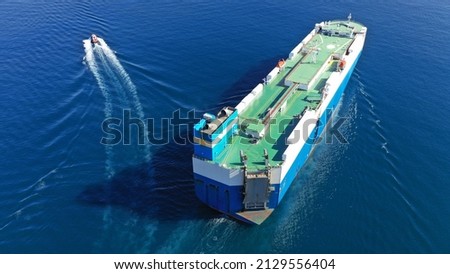 Aerial drone photo of large RO RO (Roll on - Roll Off) automobile carrier vessel cruising in deep blue open ocean sea