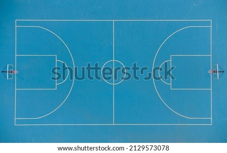 Aerial top view of the deserted basketball blue court
