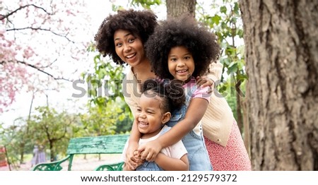 African American family doing activity and leisure an autumns day in the park. They have bright smiles and happiness.