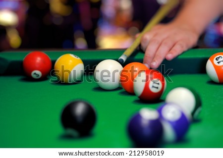 Billiard balls in a green pool table Royalty-Free Stock Photo #212958019