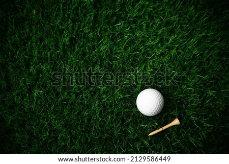 Golf ball close up on green grass on blurred beautiful landscape of golf background.Concept international sport that rely on precision skills for health relaxation.	