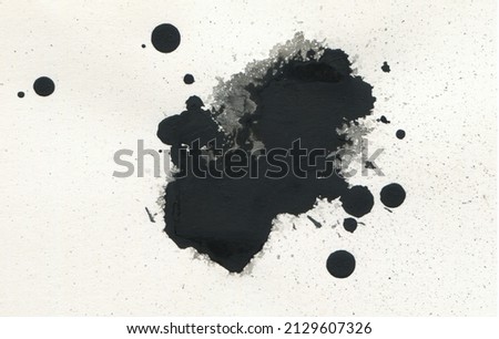 Black ink blot drops on paper texture copy space bakground. Royalty-Free Stock Photo #2129607326