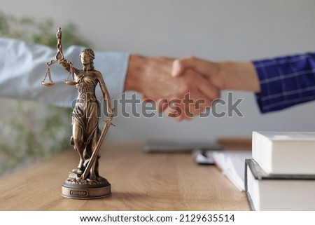 handshake of a female lawyer at a meeting with a male client in the office of the law office, legal advice online. resolution of disputes of the family code during divorce and division of property Royalty-Free Stock Photo #2129635514