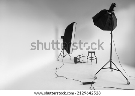 Large photo studio with cyclorama. Lighting fixtures in a photo studio. Photo studio and cyclorama. Royalty-Free Stock Photo #2129642528