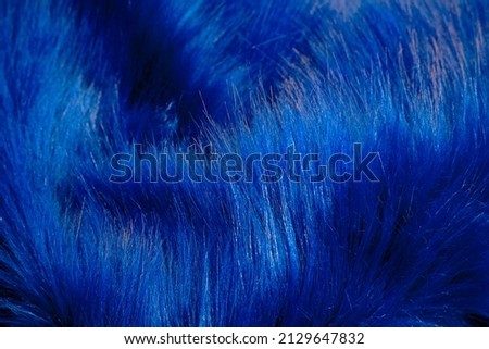 Furry fabric abstract background photo. Blue fluffy fabric with full frame.