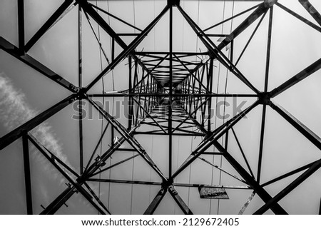 steel beams make up the intricate geometries of a high voltage pylon