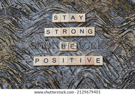stay strong be positive text on wooden square, business and motivational quotes