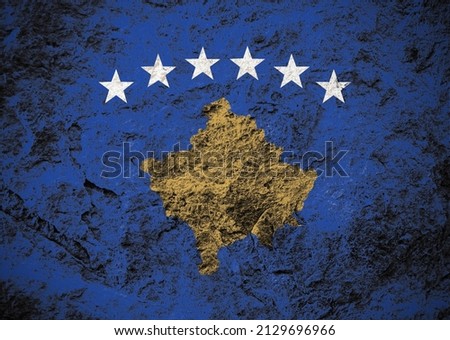 Republic of Kosovo flag on grunge stone background