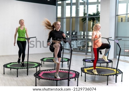 Trampoline for fitness girls are engaged in professional sports, the concept of a healthy lifestyle jumping trampoline woman fitness sport training, from workout active in lifestyle from body trainer Royalty-Free Stock Photo #2129736074