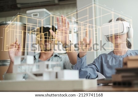 Technology futuristic virtual reality design. Team Architect or Engineer designer wearing VR headset for BIM technology working together design 3D model building in office. Royalty-Free Stock Photo #2129741168