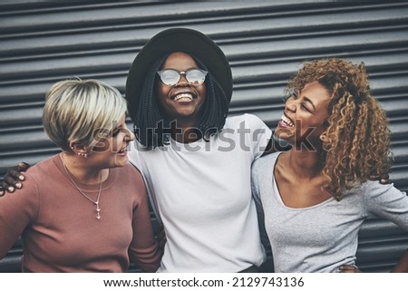 Best friends are made for laughter. Shot of a diverse group of female friends embracing each other outside. Royalty-Free Stock Photo #2129743136