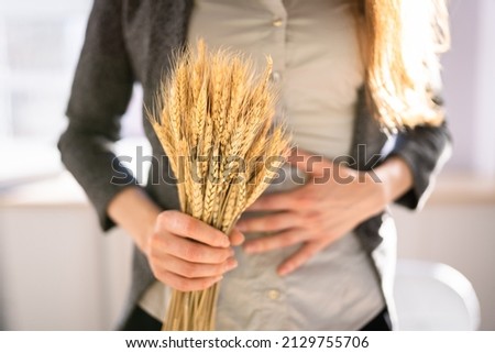 Celiac Disease And Gluten Intolerance. Women Holding Spikelet Of Wheat Royalty-Free Stock Photo #2129755706