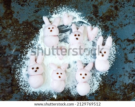 Cute pink marshmallow peeps bunny on baking tray. Cooking funny food with cartoon character. Handmade easter pastry concept. Top view from above, flat lay