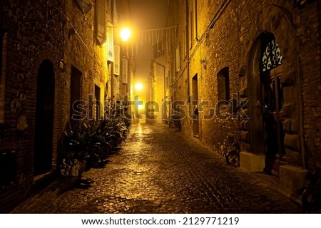 Foggy Night in a Medieval Village in Umbria Italy in Winter Royalty-Free Stock Photo #2129771219