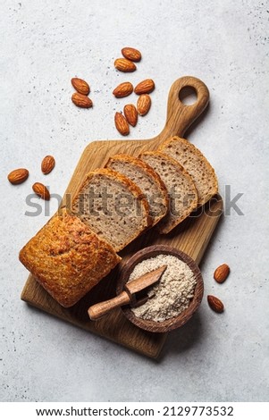 Keto bread with almond flour on a wooden board, top view. Gluten free concept. Royalty-Free Stock Photo #2129773532