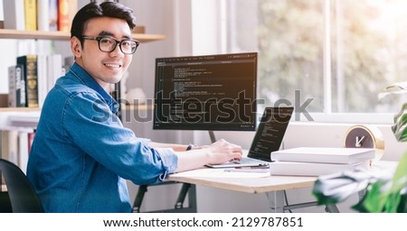 Young Asian programmer working at office Royalty-Free Stock Photo #2129787851