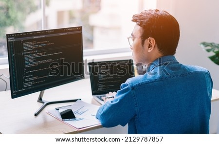 Young Asian programmer working at office Royalty-Free Stock Photo #2129787857