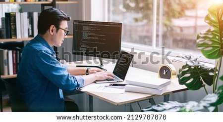 Young Asian programmer working at office Royalty-Free Stock Photo #2129787878