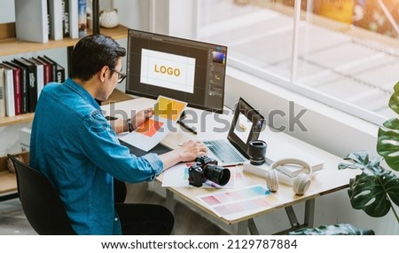 Young Asian designer working at office Royalty-Free Stock Photo #2129787884