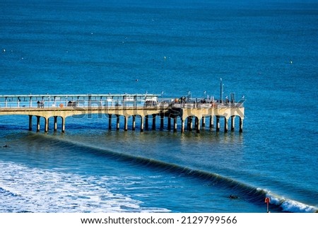 Boscombe Pier With Waves About To Break On A Clear Winters Morning Royalty-Free Stock Photo #2129799566