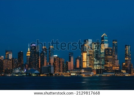 Lights of New York skyscrapers, office buildings at night, financial corporation. Manhattan skyline skyscrapers in the evening, world trade center Royalty-Free Stock Photo #2129817668