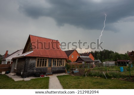 Thunderstorm with  lightning over the houses at residential area at Moscow suburb