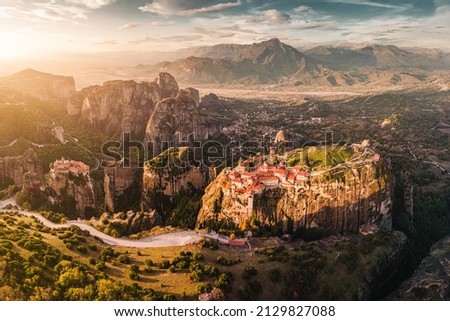 Panoramic majestic aerial view of the famous Meteora flying monasteries in Greece at sunrise. Travel to the wonders of the world. Visit travel attractions and landmarks Royalty-Free Stock Photo #2129827088