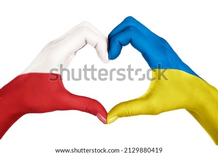 Human hands, painted with Poland and Ukraine flags,  forming heart shape isolated on white background Royalty-Free Stock Photo #2129880419