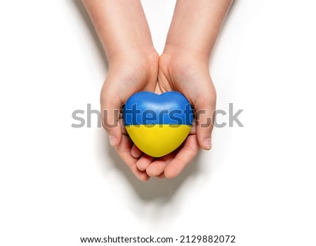 High angle view of child hands holding ukraine flag painted heart isolated on white background Royalty-Free Stock Photo #2129882072