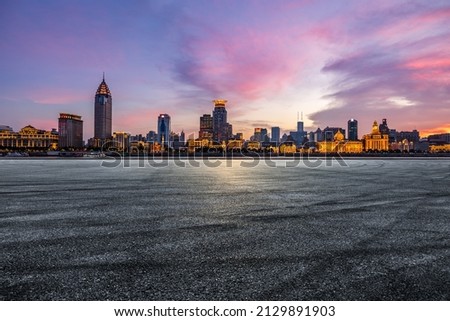 Asphalt road and city skyline with modern commercial buildings in Shanghai at night, China. Royalty-Free Stock Photo #2129891903