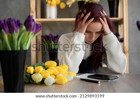 Tired, depressed, bored caucasian woman florist business owner, frustrated by business bankruptcy, frustrated, stressed worries about a problem at work. copy space. Royalty-Free Stock Photo #2129893199