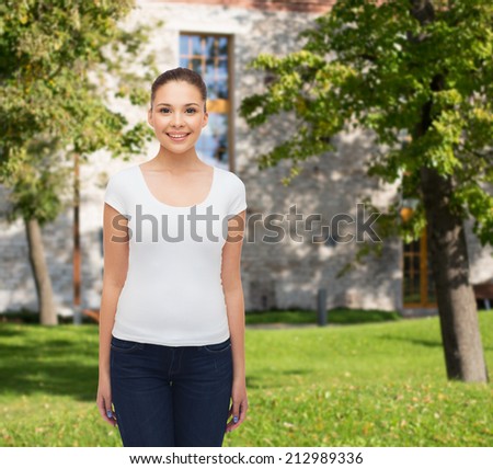advertising, summer vacation, education and people concept - smiling young woman in blank white t-shirt over campus background
