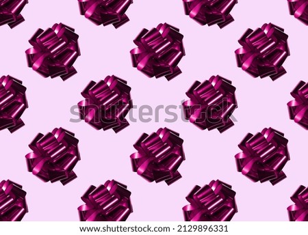 seamless pattern of pink gift bows on a light background