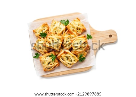 Puff pastry squares filled with feta cheese and spinach isolated on white background, top view Royalty-Free Stock Photo #2129897885